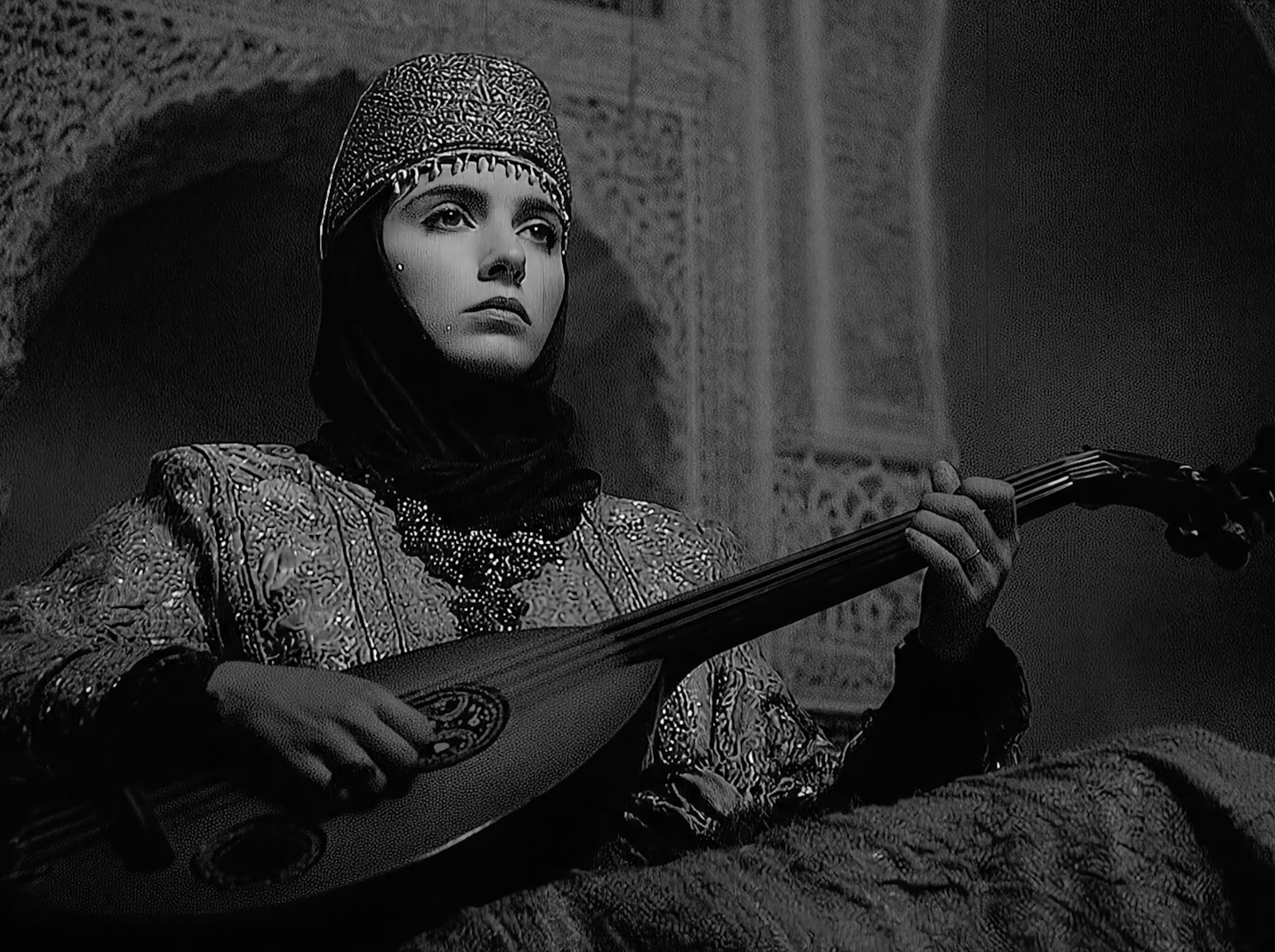A young woman playing the oud.